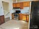 A functional kitchen featuring stainless steel appliances and wood cabinets, ready for your culinary adventures at 1608 Carfax Dr, Charlotte, NC 28216