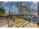 Backyard featuring a stone patio and walkway leading to the enclosed porch and landscaped yard at 161 Picwyck Dr, Mooresville, NC 28115