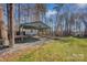 Backyard view showing covered patio and storage shed in wooded area at 161 Picwyck Dr, Mooresville, NC 28115