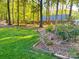 Landscaped backyard featuring flower beds and a grassy lawn at 161 Picwyck Dr, Mooresville, NC 28115