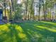 Backyard featuring a green lawn, and beautiful trees at 161 Picwyck Dr, Mooresville, NC 28115