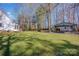 Wide lawn backyard view featuring a covered patio and storage shed at 161 Picwyck Dr, Mooresville, NC 28115