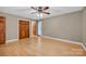 A bedroom with hardwood floors, ceiling fan, closet, neutral paint, and entrance to the outside at 161 Picwyck Dr, Mooresville, NC 28115