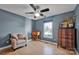 Cozy bedroom featuring a ceiling fan, wooden desk, and a comfortable chair at 161 Picwyck Dr, Mooresville, NC 28115