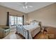 Cozy bedroom with a large window, hardwood floors, and a comfortable bed for a restful night at 161 Picwyck Dr, Mooresville, NC 28115