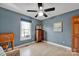 This cozy bedroom features hardwood floors, a window, and a ceiling fan at 161 Picwyck Dr, Mooresville, NC 28115