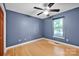 Bedroom with hardwood floors, window with blinds, and blue paint at 161 Picwyck Dr, Mooresville, NC 28115