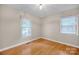 Bright bedroom featuring hardwood floors and dual windows for natural light at 161 Picwyck Dr, Mooresville, NC 28115