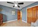 Bedroom with light-colored walls, ceiling fan, and wood-finished closet doors at 161 Picwyck Dr, Mooresville, NC 28115