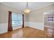 Spacious dining room with large window, hardwood floors, and stylish chandelier at 161 Picwyck Dr, Mooresville, NC 28115