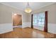 Light-filled dining room featuring hardwood floors, large window and elegant lighting at 161 Picwyck Dr, Mooresville, NC 28115