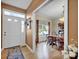 Light-filled dining room features hardwood floors, a wooden table, and neutral wall colors at 161 Picwyck Dr, Mooresville, NC 28115