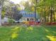 Charming home with lush lawn and colorful flowerbeds creates inviting curb appeal at 161 Picwyck Dr, Mooresville, NC 28115
