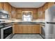 Well-lit kitchen with granite countertops, and stainless steel appliances at 161 Picwyck Dr, Mooresville, NC 28115
