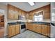 Well-lit kitchen featuring wooden cabinets, modern stainless steel appliances, and sleek countertops at 161 Picwyck Dr, Mooresville, NC 28115