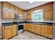 Charming kitchen with wood cabinetry, stainless appliances and granite countertops at 161 Picwyck Dr, Mooresville, NC 28115