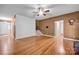 Inviting living room features gleaming hardwood floors, ceiling fan and staircase at 161 Picwyck Dr, Mooresville, NC 28115