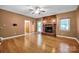 Cozy living room with a brick fireplace, hardwood floors and a ceiling fan at 161 Picwyck Dr, Mooresville, NC 28115