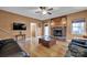 Inviting living room featuring a cozy brick fireplace, hardwood floors, and neutral paint colors at 161 Picwyck Dr, Mooresville, NC 28115