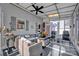 Enclosed sunroom with an outdoor patio set, ceiling fan, and ample natural light at 161 Picwyck Dr, Mooresville, NC 28115