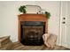 Corner fireplace with wood mantel and gas insert at 1863 Hilltop Cir, Gastonia, NC 28054