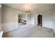 Elegant dining room with chandelier and view into living room at 2209 Kings Dr, Gastonia, NC 28056