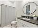 Clean bathroom with dark countertop, white cabinets, and modern fixtures at 243 Reese Wilson Rd, Belmont, NC 28012