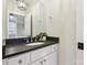 Clean bathroom with dark countertop, white cabinets, and modern fixtures at 243 Reese Wilson Rd, Belmont, NC 28012