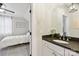 Clean bathroom with dark countertop, white cabinets, and modern fixtures at 243 Reese Wilson Rd, Belmont, NC 28012