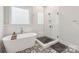 Modern bathroom with soaking tub and walk-in shower at 243 Reese Wilson Rd, Belmont, NC 28012