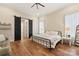 Bright bedroom with wood floors and black metal bed frame at 243 Reese Wilson Rd, Belmont, NC 28012