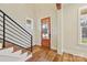 Bright entryway with hardwood floors, wooden staircase, and a wood door at 243 Reese Wilson Rd, Belmont, NC 28012