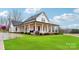 White farmhouse exterior with a large front porch and landscaped lawn at 243 Reese Wilson Rd, Belmont, NC 28012