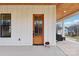 Front door entry with a wood door and white exterior at 243 Reese Wilson Rd, Belmont, NC 28012