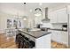 Modern kitchen with white cabinets, dark countertops, and island seating at 243 Reese Wilson Rd, Belmont, NC 28012