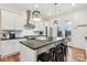 White kitchen with stainless steel appliances and an island with farmhouse sink at 243 Reese Wilson Rd, Belmont, NC 28012