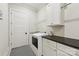 Bright laundry room features washer, dryer, and ample cabinet space at 243 Reese Wilson Rd, Belmont, NC 28012