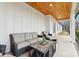 Relaxing covered porch with wicker furniture and wood ceilings at 243 Reese Wilson Rd, Belmont, NC 28012