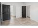 Bright bedroom with light wood floors and dark doors leading to other rooms at 250 Franklin Nw Ave, Concord, NC 28025