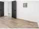 Spacious bedroom featuring light wood floors and dark doors at 250 Franklin Nw Ave, Concord, NC 28025
