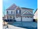 Two-story house with stone accents and a three-car garage at 276 Annatto Way, Fort Mill, SC 29708