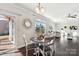 Bright dining area with backyard access, hardwood floors, and views into the living room at 276 Annatto Way, Tega Cay, SC 29708