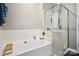 Bathroom featuring a soaking tub and glass shower at 3834 Sipes Ln, Charlotte, NC 28269