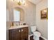 Half bath boasts wood vanity and modern fixtures at 3834 Sipes Ln, Charlotte, NC 28269