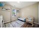 Bright bedroom features a rocking chair, rug, and window providing natural light at 3834 Sipes Ln, Charlotte, NC 28269
