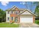 Charming two-story home featuring a well-maintained lawn, brick facade, and attached two-car garage at 3834 Sipes Ln, Charlotte, NC 28269