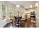Bright kitchen with stainless steel appliances, white cabinets, and a cozy breakfast nook at 3834 Sipes Ln, Charlotte, NC 28269