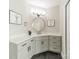 Modern bathroom with a corner vanity, frameless mirror, and dark-grey tile floors at 4150 Summit Ridge Ln, Denver, NC 28037