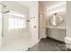 Spa-like bathroom with walk-in shower, built-in bench and large window at 4150 Summit Ridge Ln, Denver, NC 28037