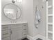 Bathroom featuring gray vanity with a round mirror and gold hardware at 4150 Summit Ridge Ln, Denver, NC 28037